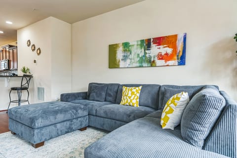 Bright living room with oversized sectional and open kitchen seating