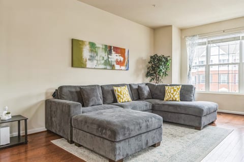 Bright, spacious living room with oversized sectional and natural light