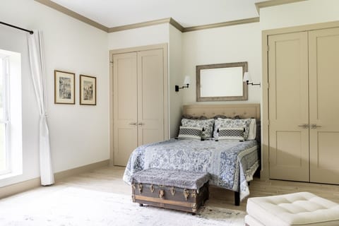 Bright elegant bedroom with natural light, dual closets, and stylish accents