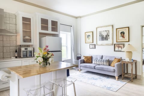 Bright open-plan kitchen and lounge with island seating and elegant décor