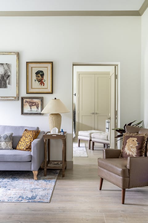 Bright, elegant living room with curated decor and cozy seating