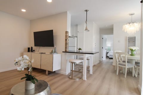 Living room with smart TV, open to the dining area