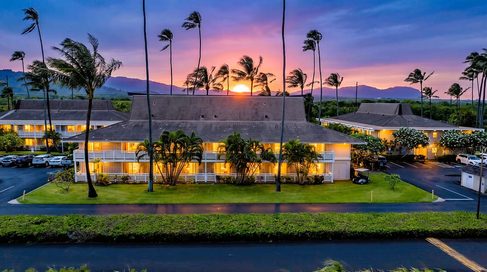 Sunset behind the mountains, warm lights glowing — this is what arriving at paradise feels like.