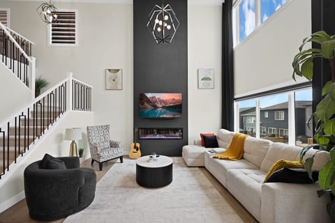 Soaring ceilings, designer fireplace, and a bright, inviting living space