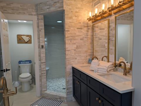 Modern main bathroom with two sinks, shower, and tub