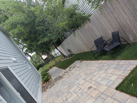 Beautiful patio area with turf grass and seating