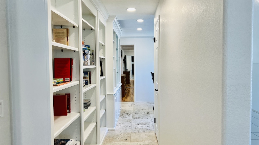 Hallway features a built-in with books, puzzles, and games for families to enjoy. - SilverSurf Gardens - Oceanside