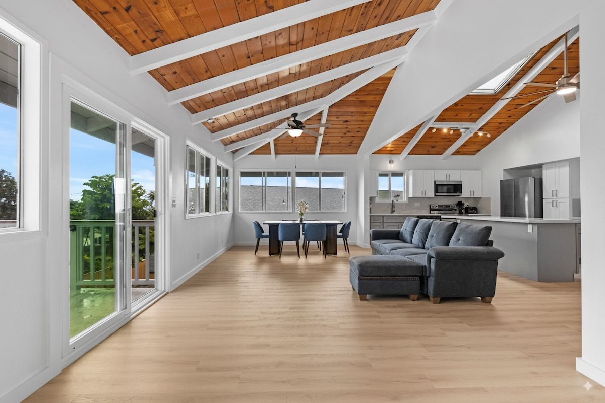 bright, open living and dining with soaring vaulted ceilings — perfect after a day at the beach