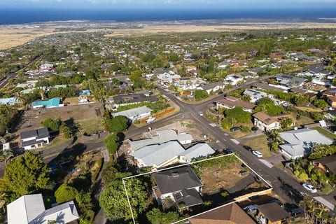 Aerial view of peaceful Kona Palisades with the ocean and Kona Airport visible in the distance