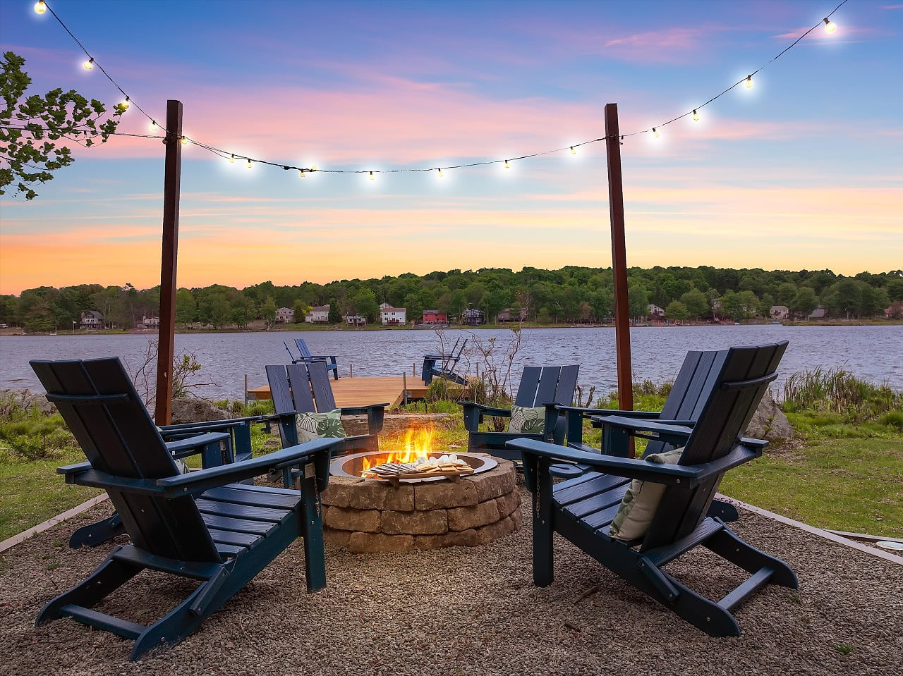 Experience magical twilight moments by the firepit, set beside the dock with serene lakefront views.