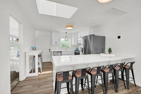 Bright modern kitchen with large island seating for 6 and skylight