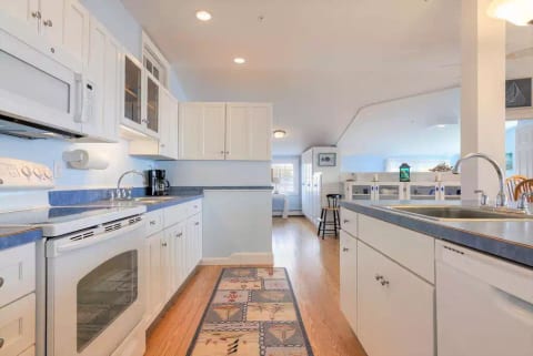 kitchen - includes electric stove/oven, full size refrigerator with ice maker, dishwasher, coffee maker, blender, mixer