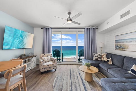 Floor-to-ceiling balcony access fills the living room with natural light and showcases unforgettable views of the emerald coast.