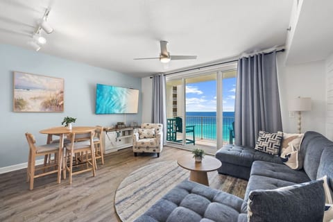 Relax in the bright open-concept living area with comfortable seating and breathtaking Gulf-front views.