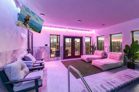 Modern poolside lounge with mountain views and vibrant ambient lighting