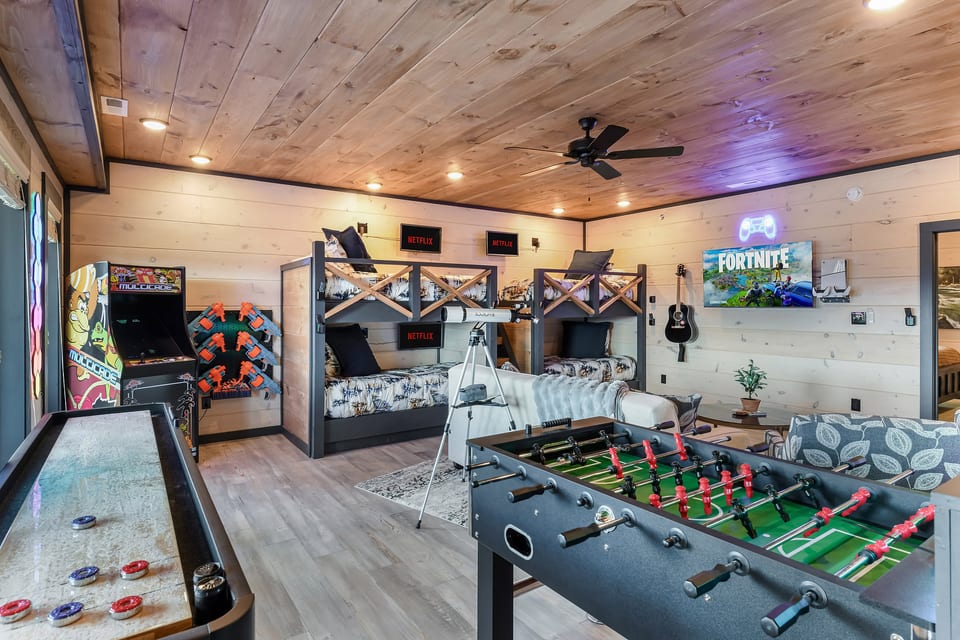 Game-packed bunk room with arcade, foosball, shuffleboard & TV gaming