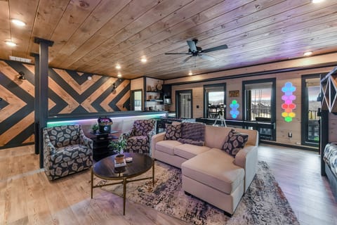 Cozy lounge with pool table, mood lighting, and modern cabin style