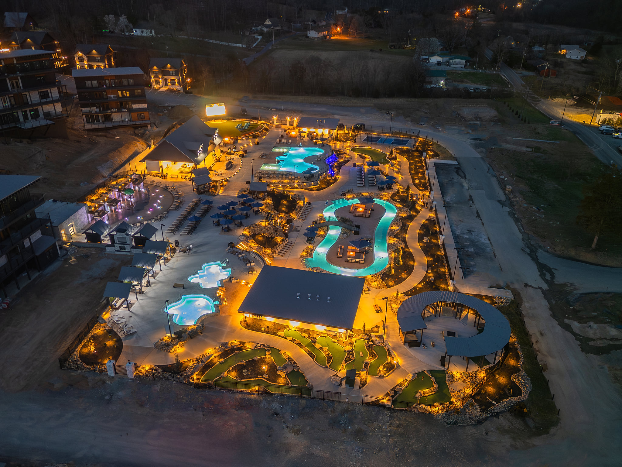 Stunning resort-style pools and hot tubs glowing at twilight
