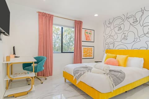 Cozy bedroom w/ pops of yellow, comfy bedding, and natural light for restful mornings and slow nights.