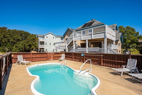 Sunlit backyard pool w/ fenced yard, perfect for cooling off after a day of coastal adventures.