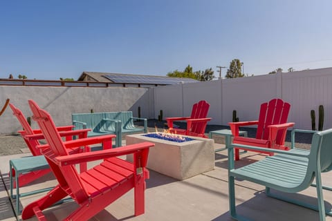 Outdoor hangout w/ fire pit & bold seating, made for evening chats under the desert sky.