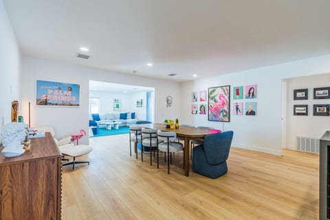 Open dining area filled w/ natural light, colorful art, & space to gather for meals or games.