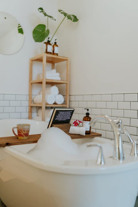 Deep soaker tub is located in the bedroom (no shower available)