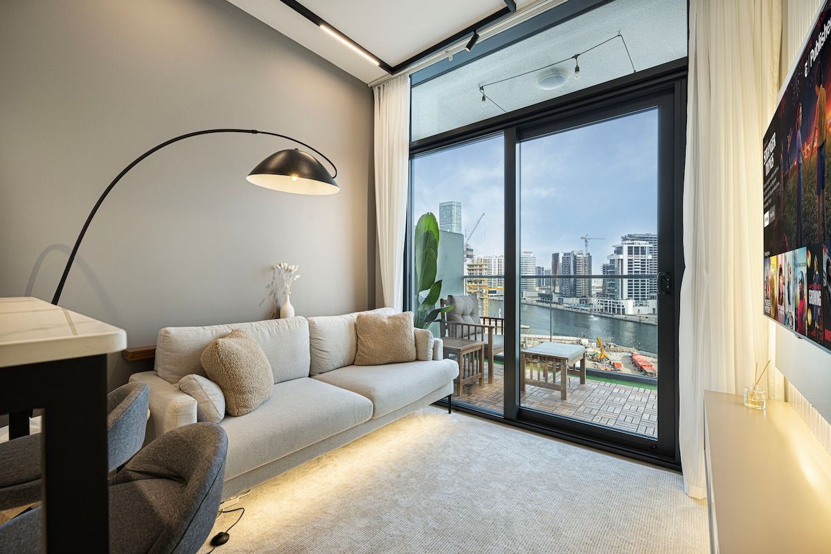 Bright living room with balcony access • City skyline views