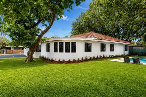 Spacious backyard featuring a private pool and pickleball court