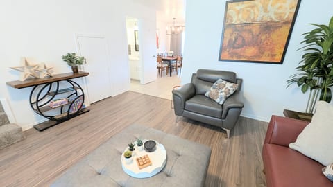 Living room has direct access to the half bath, dining room, and kitchen.