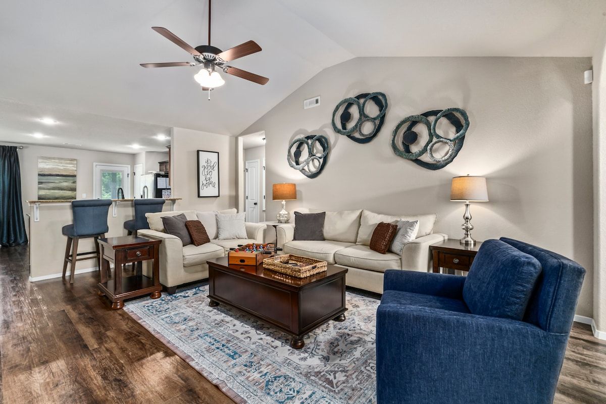 Bright & open living room with plenty of comfortable seating for your whole crew!