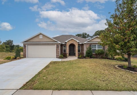 Charming brick & stone home on a quiet, tree-lined street in Lowell, AR. Single-story, step-free, with wide driveway and 2-car garage. Central to all of NW Arkansas.