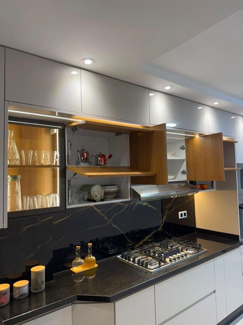 Sleek designer kitchen with gas cooktop and stylish lit cabinetry