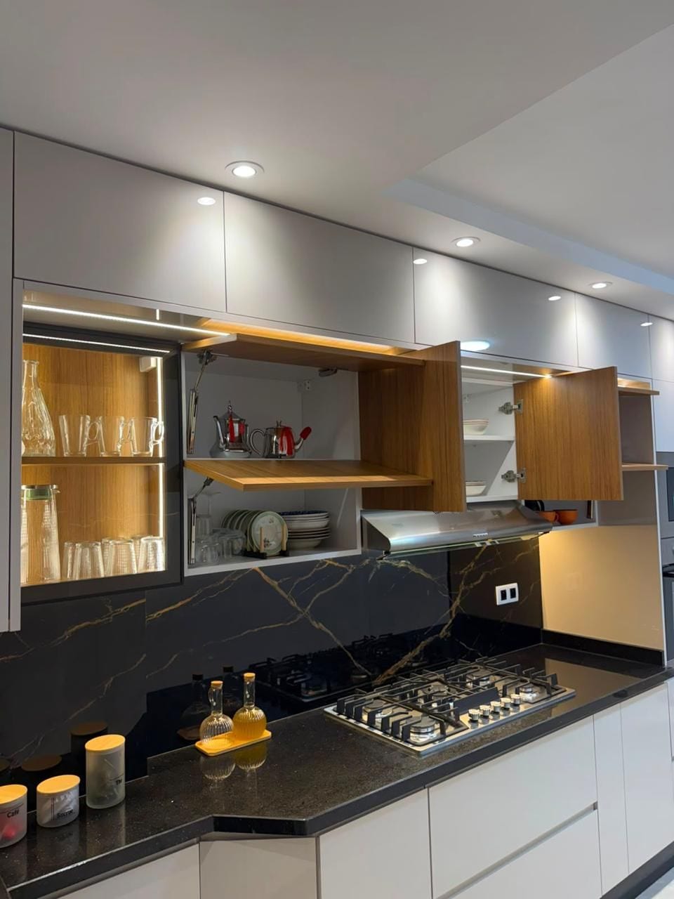 Sleek designer kitchen with gas cooktop and stylish lit cabinetry