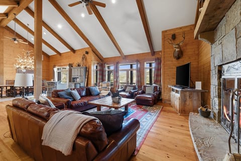 Spacious great room with vaulted ceilings, fireplace, and room to gather