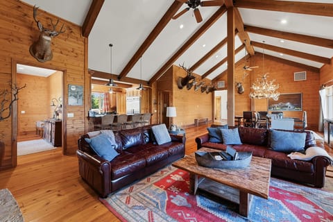 Open-concept lodge living area with dining space and rustic mountain style