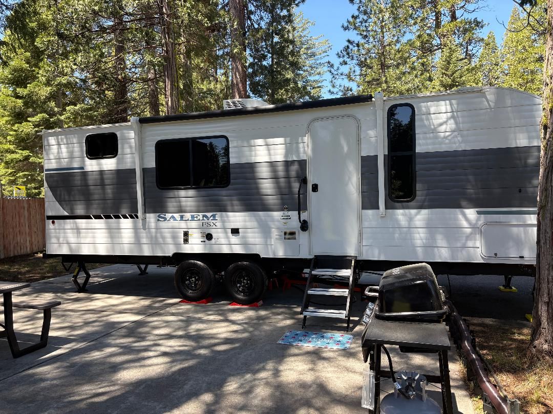 Your home base in the pines — a brand-new, fully equipped travel trailer with everything you need and nothing you don't. Pull up, settle in, and let the mountains do the rest.