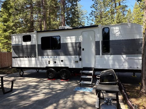 Your home base in the pines — a brand-new, fully equipped travel trailer with everything you need and nothing you don't. Pull up, settle in, and let the mountains do the rest.
