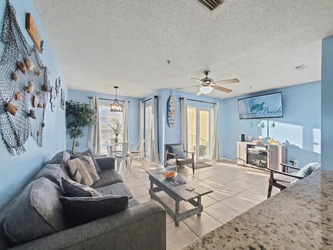 Main living area. 55-inch Roku smart TV, electric fireplace, pull out queen sofa bed (memory foam mattress), two chairs, dining area with glass table and four chairs. Outdoor balcony with a view of the Santa Rosa Sound with padded chairs and table