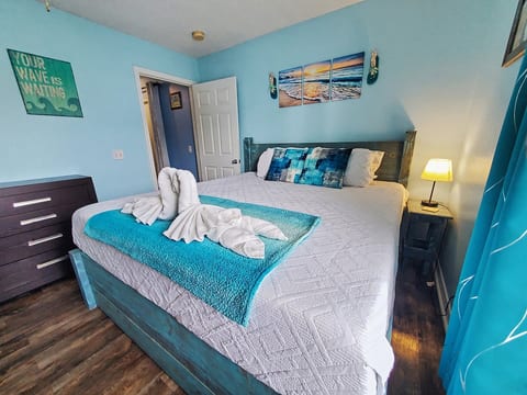 Master bedroom. Work desk and a rolling chair in the corner including a large mirror. Chest of drawers, king size memory foam bed, and a 32 Roku Smart TV.