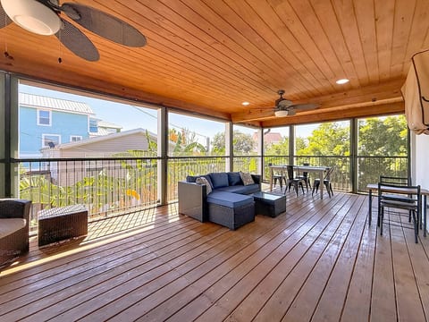 Screened patio with seating & smart tv