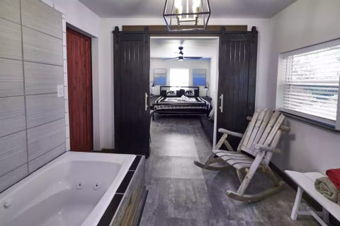 Sliding barn doors from the king bedroom lead to a stylish and sophisticated ensuite full bathroom