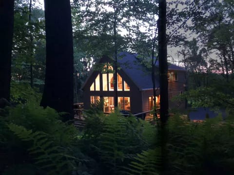 Nestled deep in the woods means total tranquility. Relax on the over sized deck