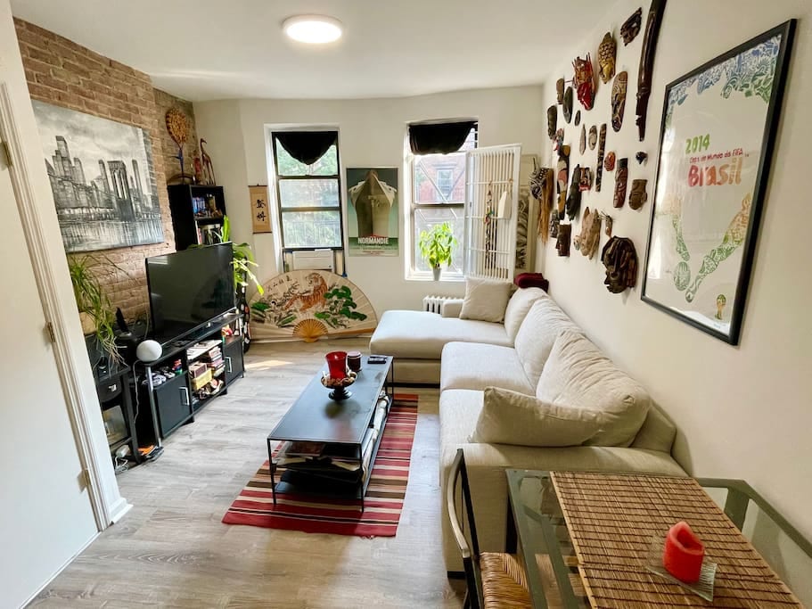 Living room with brand new, bigger sofa with chaise and dining table