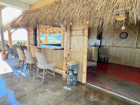 Tiki bar with TV, ice maker, fridge, darts and a bathroom (not pictured)