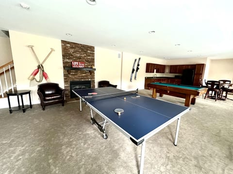 lower level game room with poker, ping pong, pool, and kitchenette.