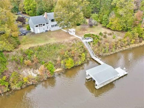 Aerial shot of the home and dock - plenty of green space out back.