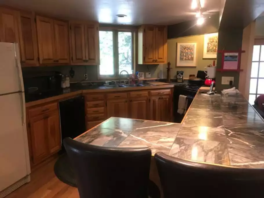 Inside The Treehouse, the kitchen is fully equipped. - Romantic, nature lover’s retreat! Hot tub, trails - Lamoille County