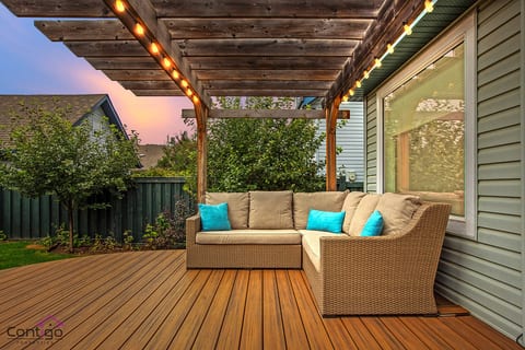 Charming outdoor living space with string lights and stylish patio seating – the perfect escape.