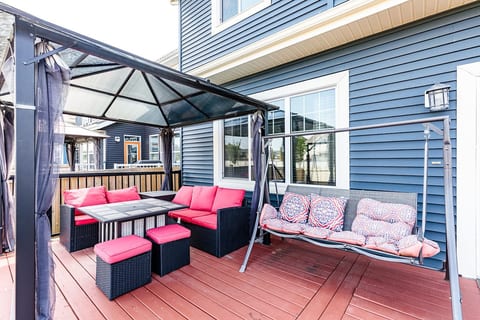 Enjoy the outdoor patio with comfortable sofas and a swing seat. Perfect for relaxing or socializing in the fresh air.